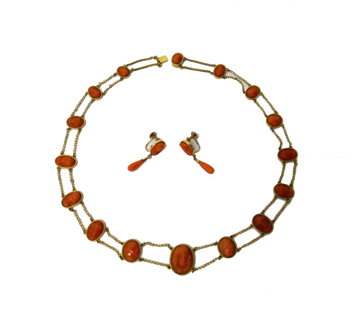 Appraisal: A gold and carved coral cameo necklace formed as a