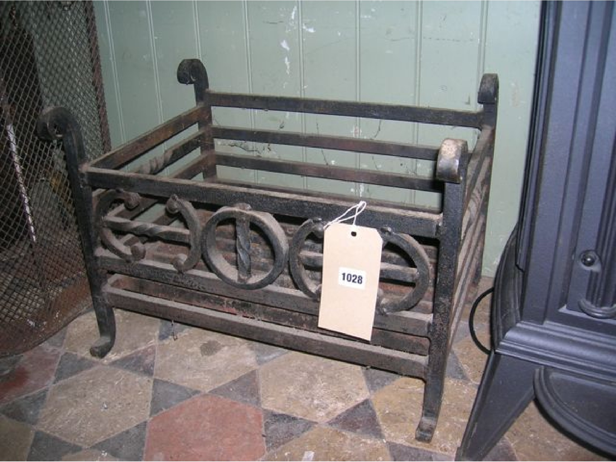 Appraisal: A cast iron fire basket of rectangular form with scrolled