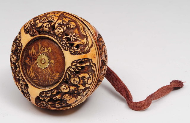 Appraisal: A Japanese ivory Manju netsukeMeiji periodcarved with panels of karako