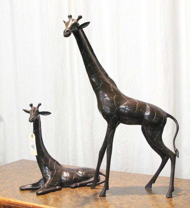 Appraisal: TWO BRONZE WILDLIFE SCULPTURES two African giraffe standing and recumbent