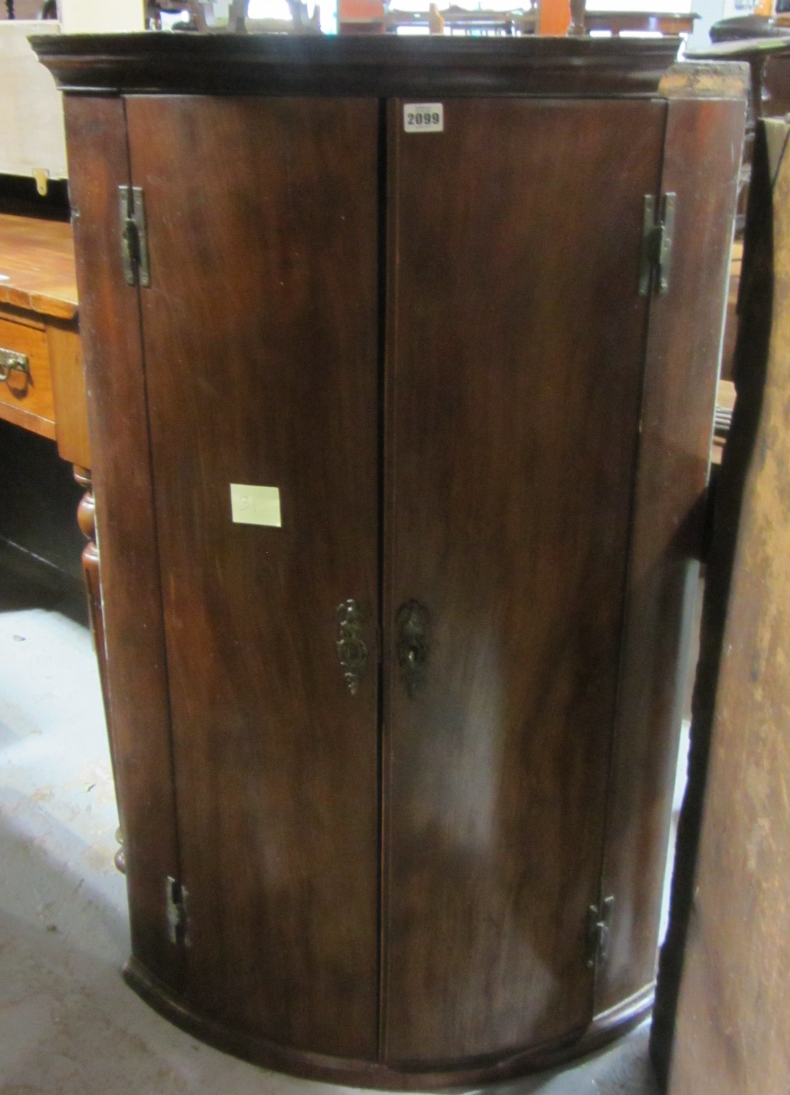 Appraisal: A th century mahogany bowfront hanging wall cupboard