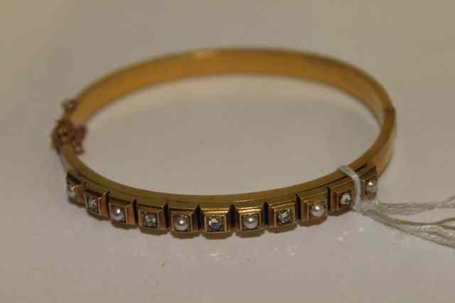 Appraisal: A VICTORIAN CT GOLD BANGLE with alternating pearl and diamond