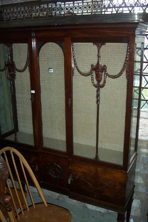 Appraisal: An Edwardian mahogany inverted breakfront china display cabinet with urn