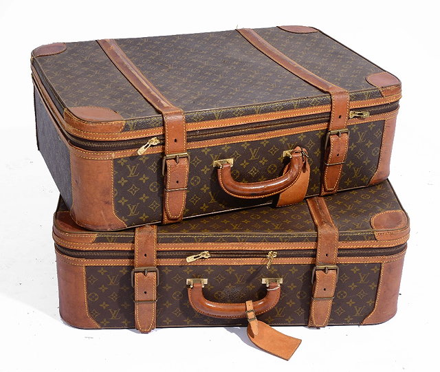 Appraisal: A PAIR OF LOUIS VUITTON LEATHER BOUND SUITCASES with traditional