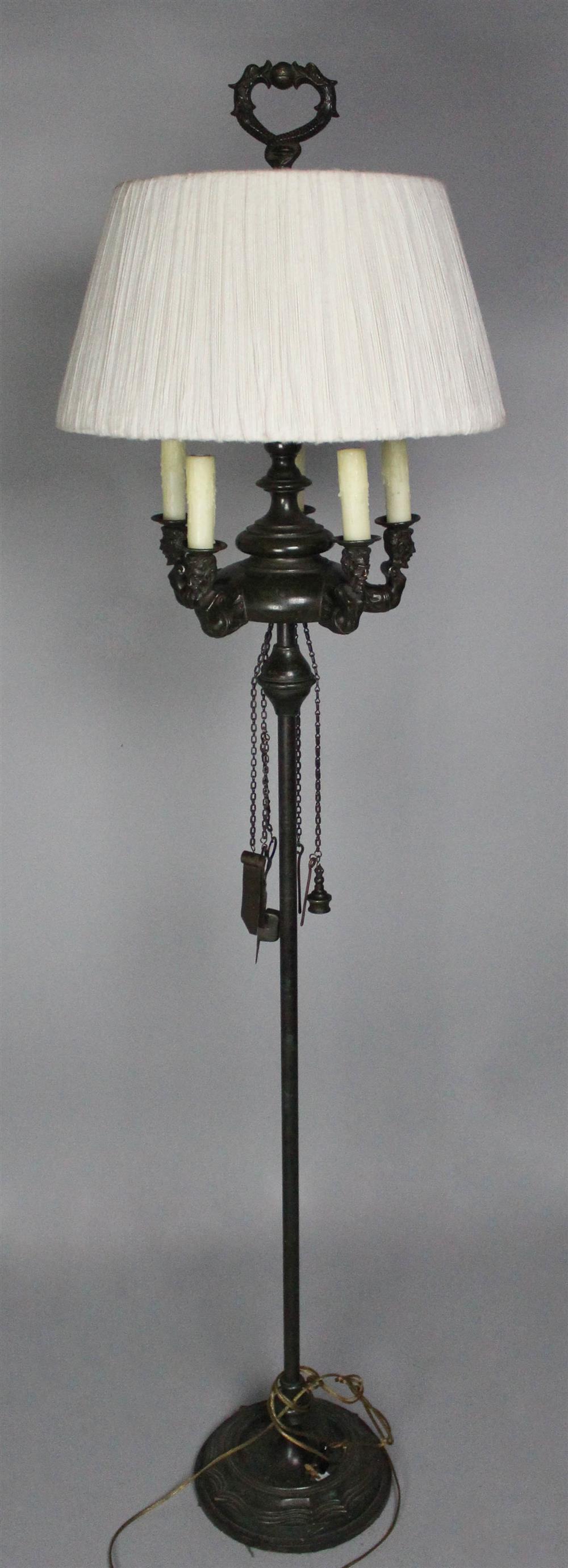 Appraisal: PATINATED BRONZE FIGURAL OIL FLOOR LAMP late th Century suspended