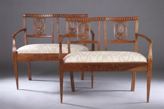 Appraisal: PAIR CONTINENTAL NEOCLASSICAL FRUITWOOD SETTEES Late th century Each double-chairback