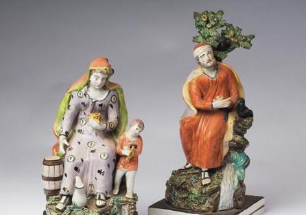 Appraisal: PAIR OF STAFFORDSHIRE PEARLWARE FIGURAL GROUPS OF 'CHARITY' AND 'ELIJAH