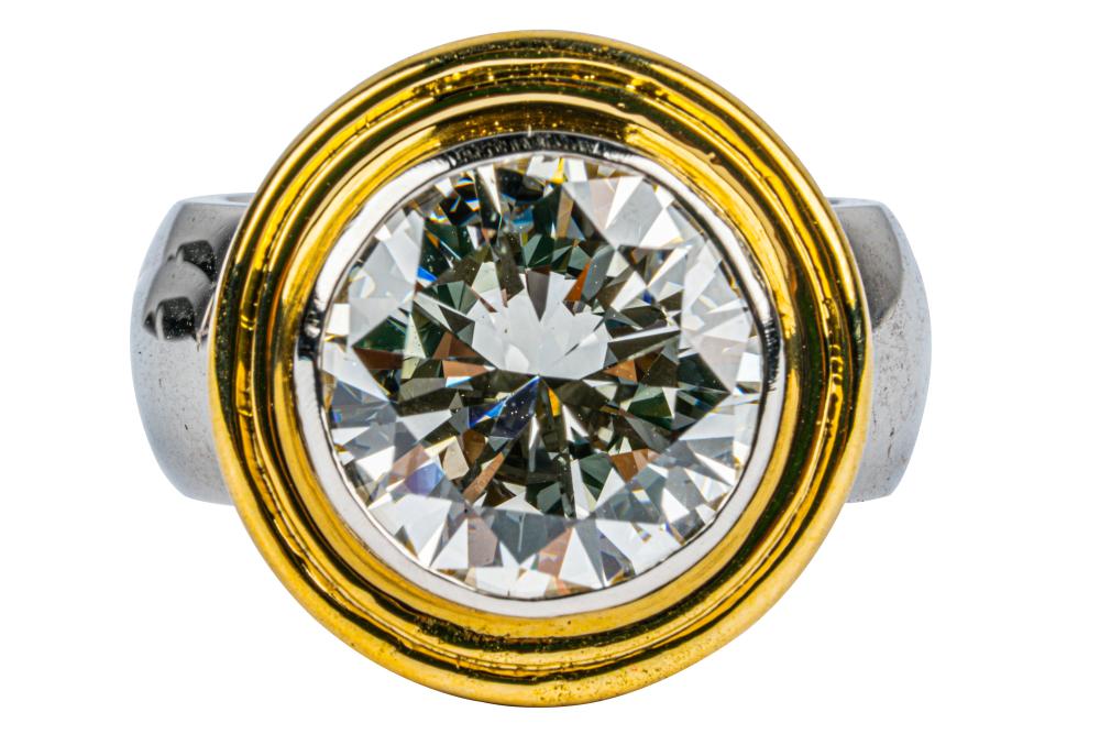 Appraisal: PLATINUM KARAT GOLD DIAMOND RINGcentering one bezel set round brilliant