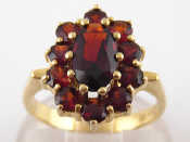 Appraisal: A yellow metal tests gold garnet ring marked the principal