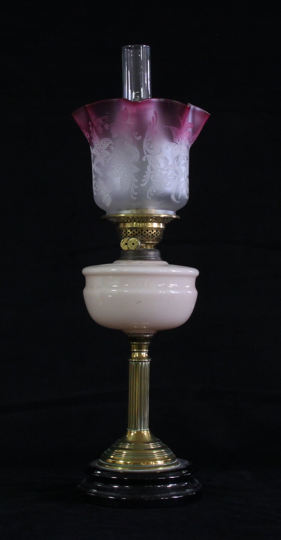 Appraisal: A Victorian oil lamp with pink etched glass shade opaque