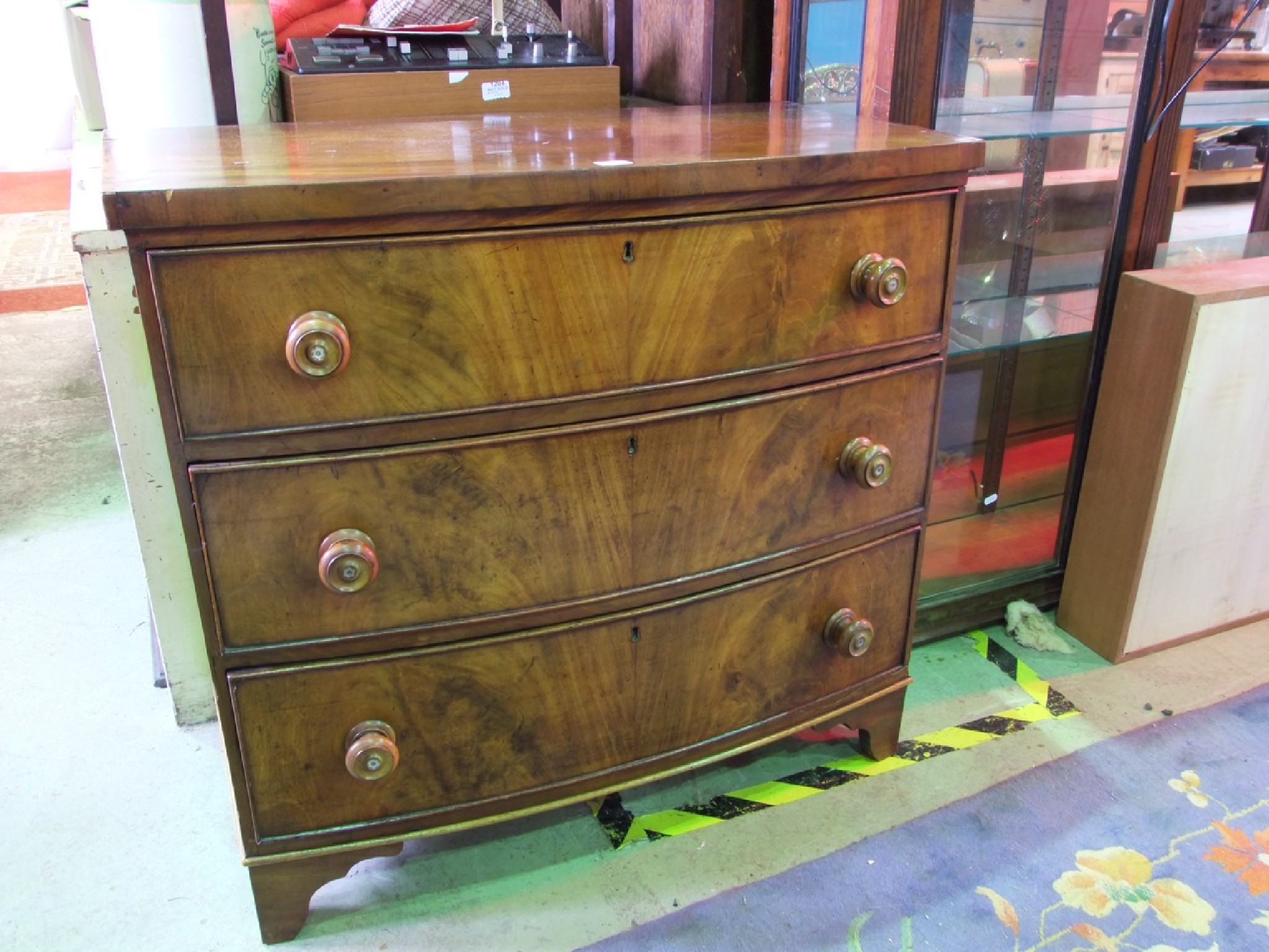 Appraisal: A th century bow fronted bedroom chest of long drawers