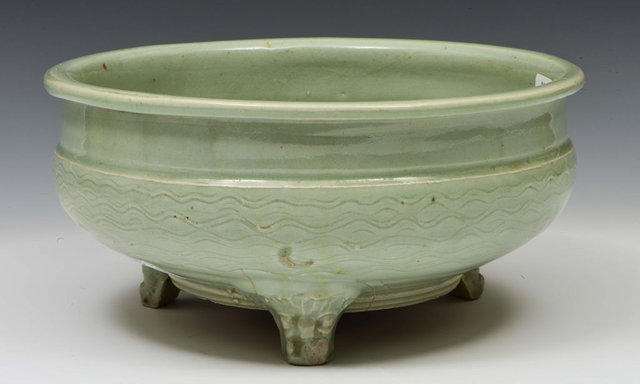 Appraisal: A CHINESE CELADON CENSER of circular form standing on three