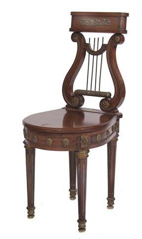 Appraisal: A FRENCH EMPIRE STYLE MAHOGANY HARPISTS CHAIR the top rail