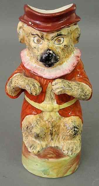 Appraisal: Staffordshire standing bear jug th c with jacket and cap