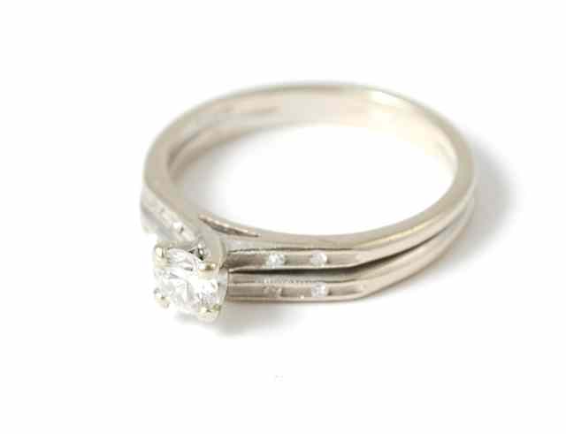 Appraisal: DIAMOND AND FOURTEEN KARAT WHITE GOLD WEDDING RING SET featuring