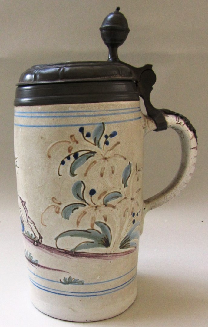 Appraisal: A German faience pewter mounted tankard late th century painted