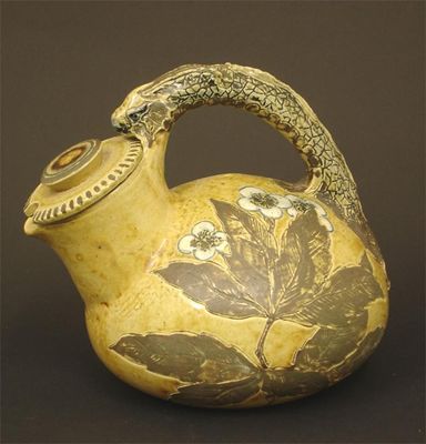 Appraisal: A Martin Brothers stoneware jug compressed form with over-slung grotesque