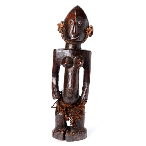 Appraisal: Tribal art A Yoruba wood female figure with fibre skirt