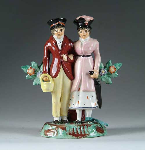 Appraisal: STAFFORDSHIRE FIGURAL GROUP OF MAN AND WOMAN Man on left