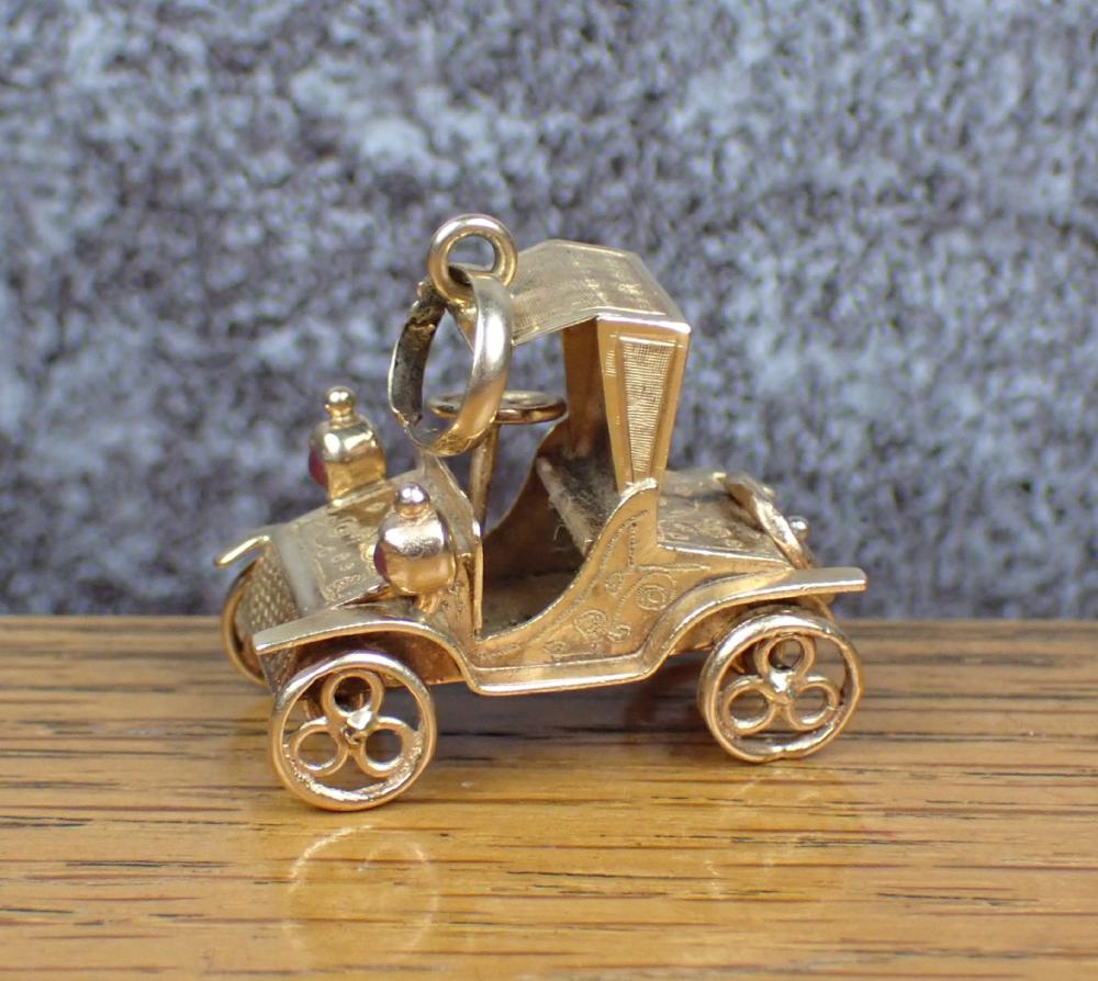 Appraisal: VINTAGE EIGHTEEN KARAT GOLD ANTIQUE CAR CHARM The k gold