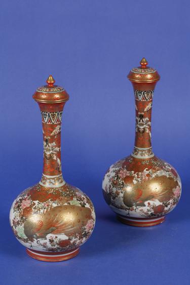 Appraisal: A PAIR OF JAPANESE SATSUMA BOTTLE VASES AND LIDS decorated