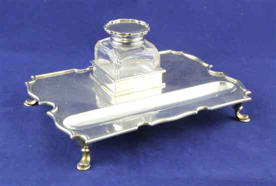 Appraisal: An Edwardian silver inkstand of shaped rectangular form on hoof