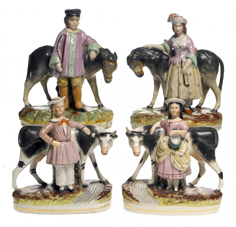 Appraisal: A PAIR OF STAFFORDSHIRE EARTHENWARE FIGURES OF A FARMER AND