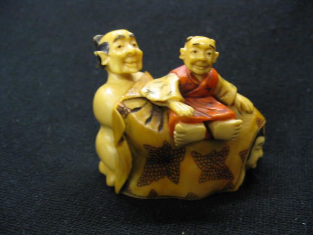 Appraisal: Carved Ivory Erotic Netsuke man seated on blanket with man