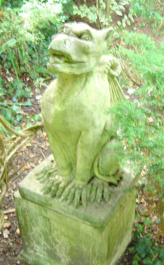 Appraisal: Composition garden statue of a mythical dragon seated on its