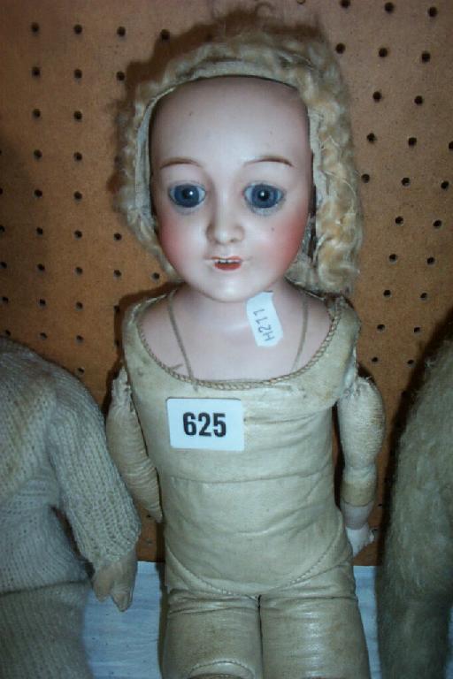 Appraisal: A th century porcelain headed doll with blue paperweight eyes