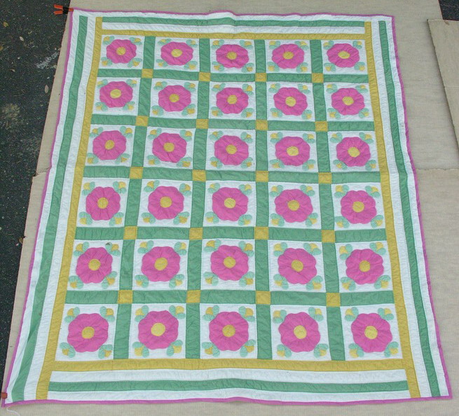 Appraisal: APPLIQUED QUILT WITH LARGE FLOWERS Hand appliqued hand quilted Quilting