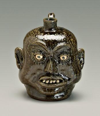 Appraisal: Lanier Meaders face jug runny alkaline glaze stoneware heavy cheeks