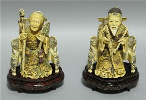 Appraisal: PAIR OF CHINESE IVORY FIGURES Carved as an emperor and