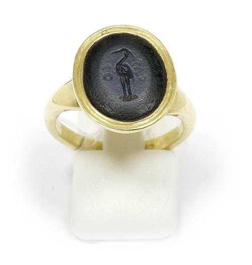 Appraisal: RING WITH ANTIQUE INTAGLIO Yellow gold Oval Roman Nicolo intaglio