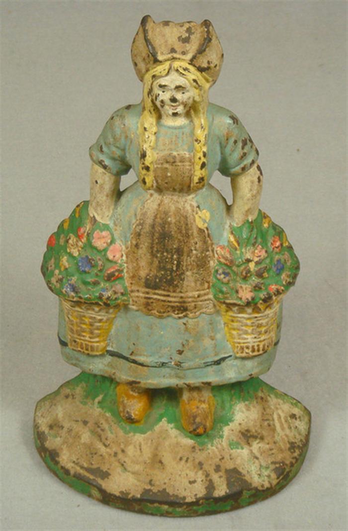 Appraisal: Cast iron doorstop colorful Dutch girl with two flower baskets