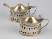 Appraisal: A pair of silver pierced oval lidded mustard pots with