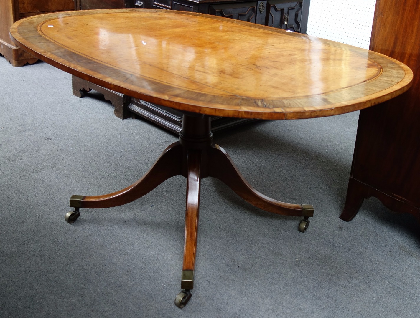 Appraisal: A George III rosewood banded satinwood oval snap top breakfast