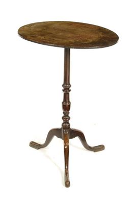 Appraisal: A mahogany tripod table the oval top on a slender