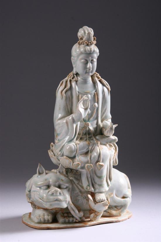 Appraisal: CHINESE QINGBAI PORCELAIN FIGURE OF GUANYIN AND FU LION Seated