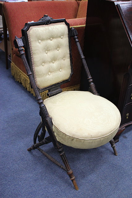 Appraisal: A VICTORIAN EBONISED AESTHETIC CHAIR with rectangular button upholstered inset