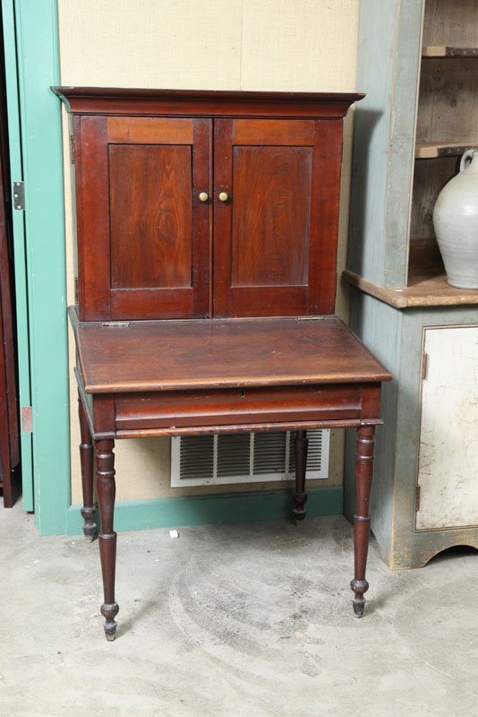 Appraisal: PLANTATION DESK Of typical form in dark walnut on turned