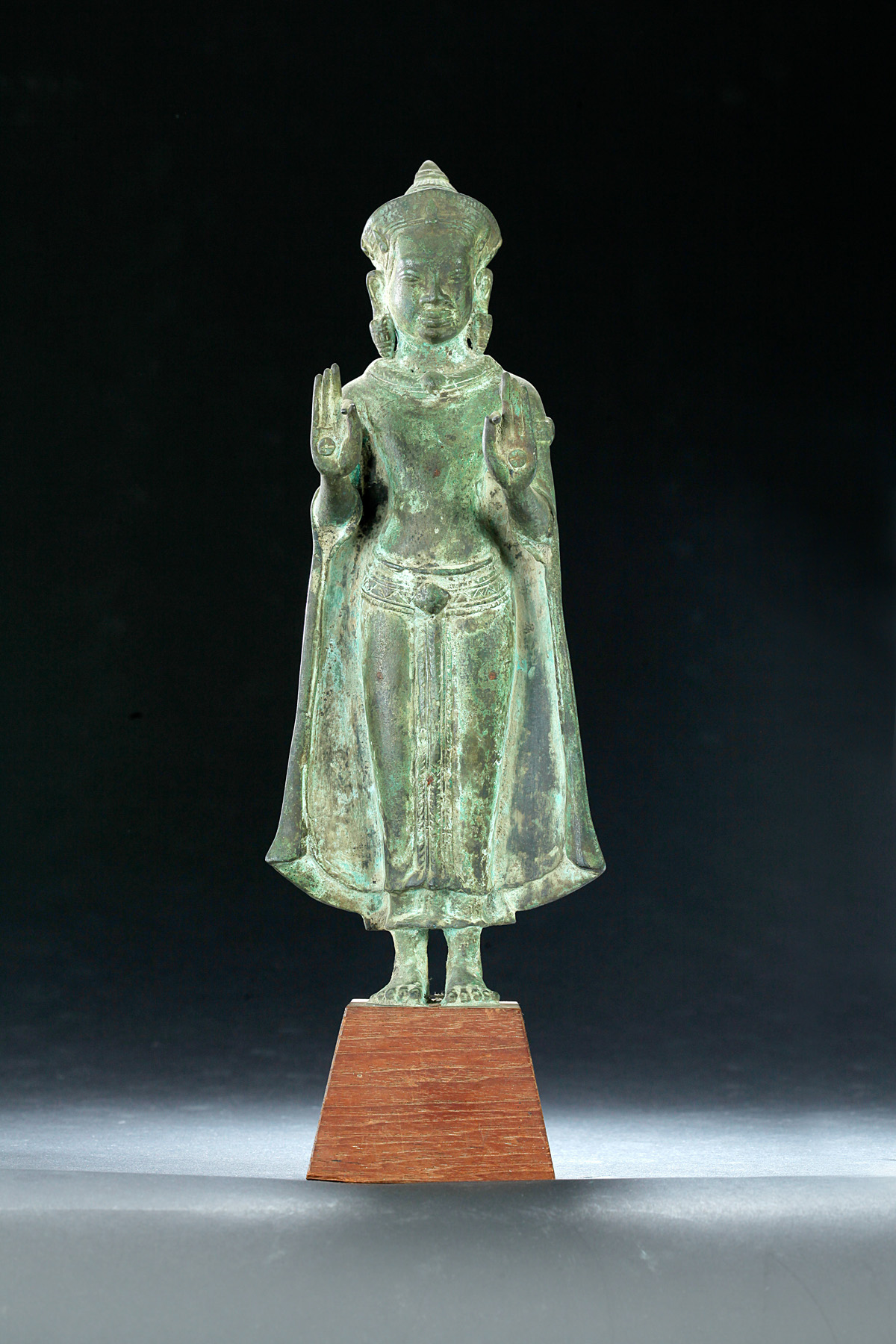 Appraisal: BRONZE BUDDHA Probably Thailand th century Robed figure with medallions