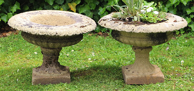 Appraisal: A PAIR OF TH CENTURY COMPOSITE STONE URNS of campana