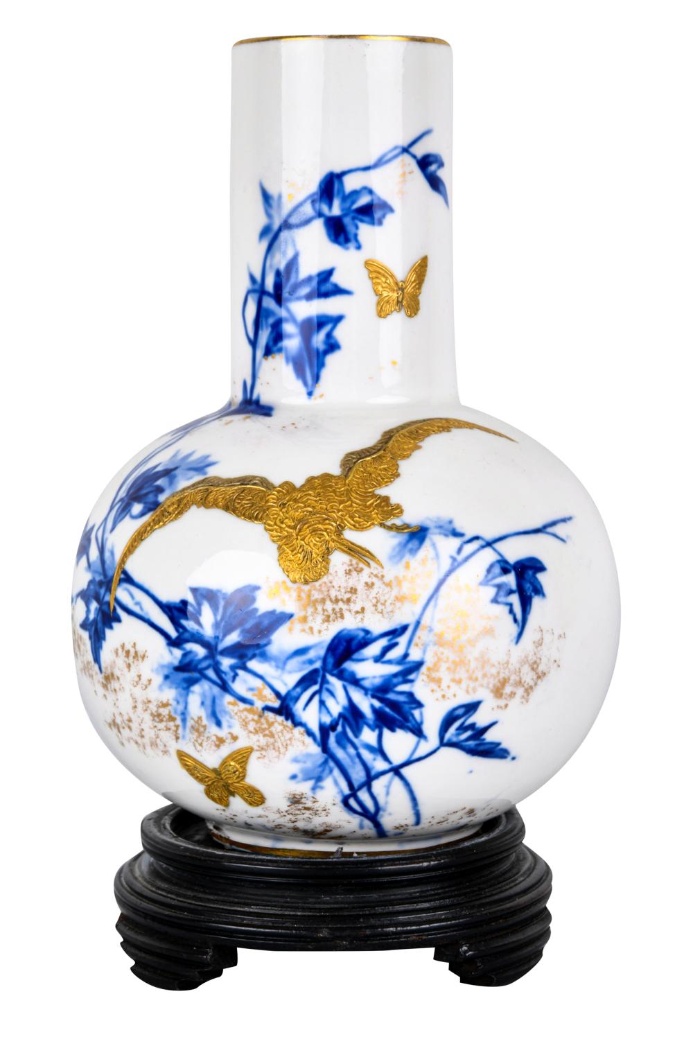 Appraisal: GILT OVERLAY BLUE WHITE VASEon a wood base the vase