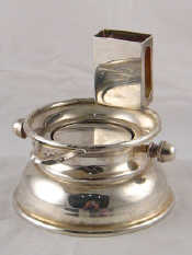 Appraisal: A silver plated combined matchbox holder and automatic ashtray with