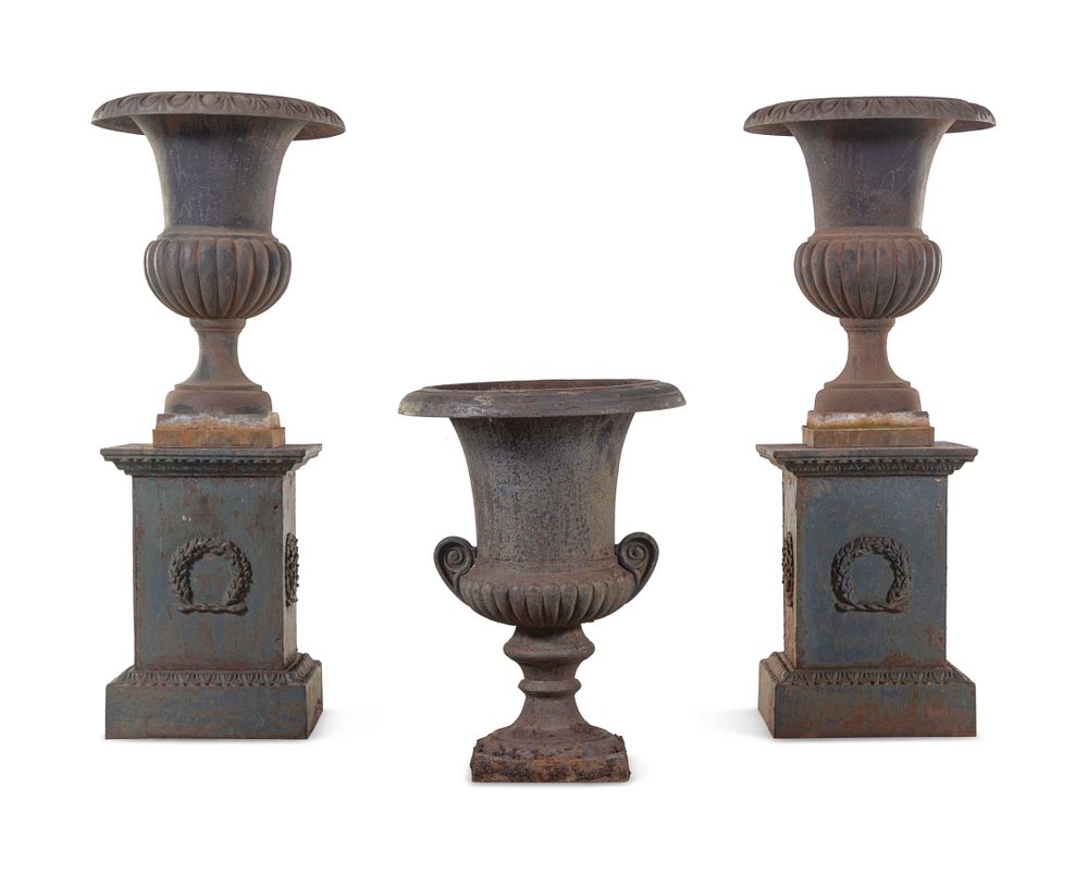 Appraisal: A Pair of Iron Garden Urns with Associated Plinths and