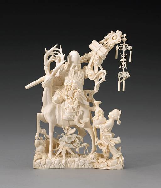 Appraisal: A pieced ivory figural group of Shoulao and attendant th