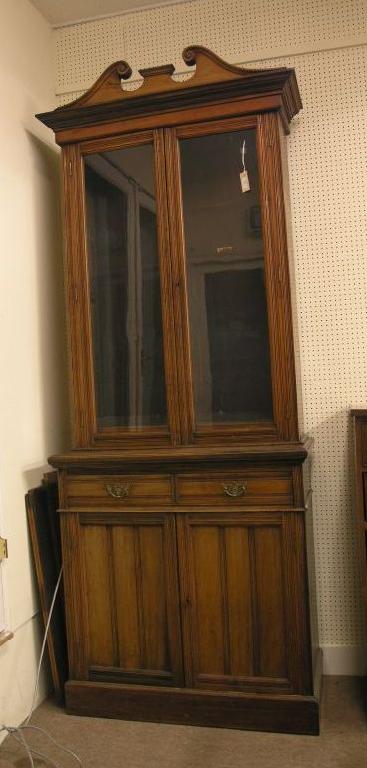 Appraisal: A late Victorian walnut tall bookcase upper stage with swan-neck