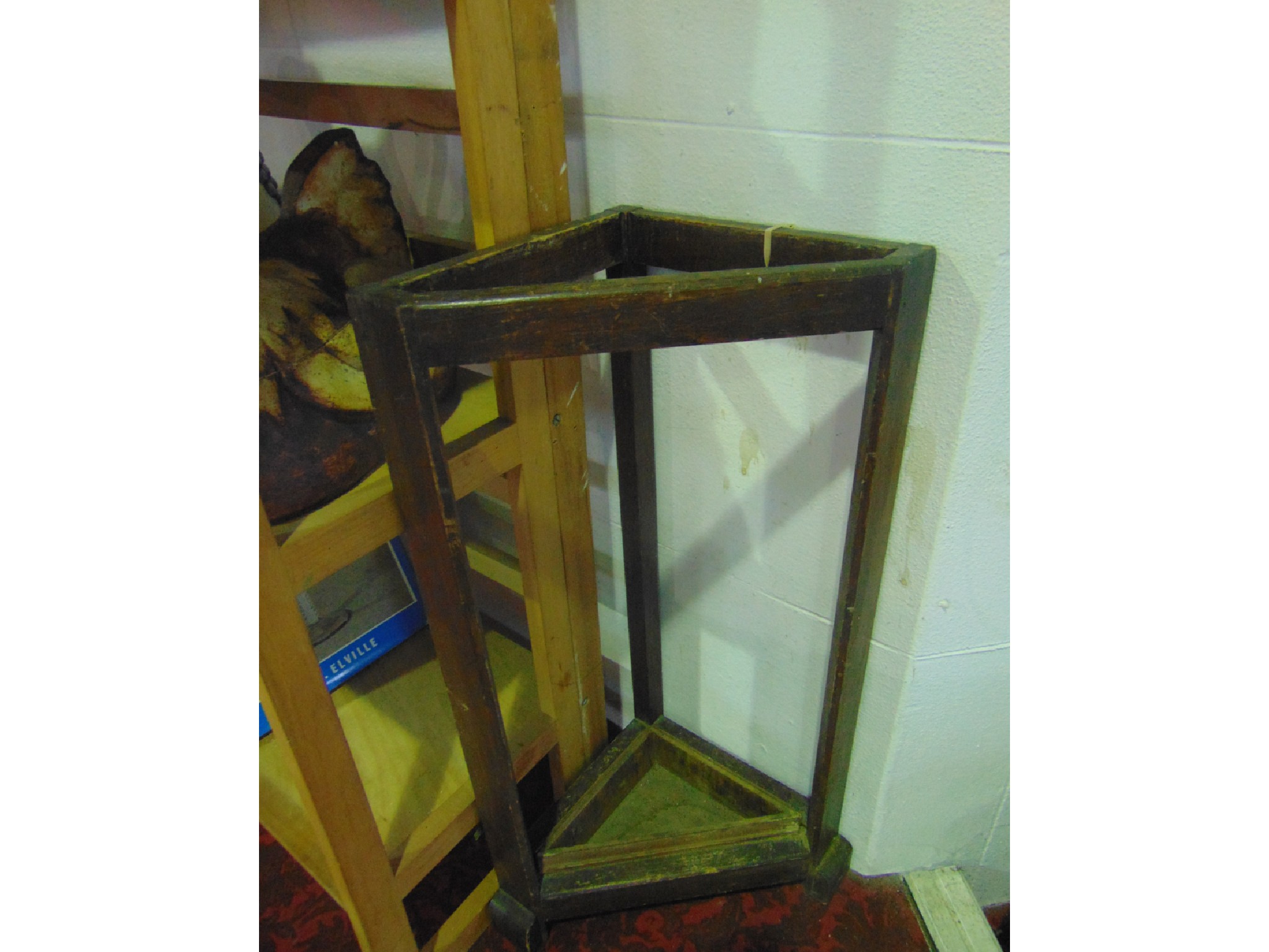 Appraisal: A stained timber stick stand of triangular form