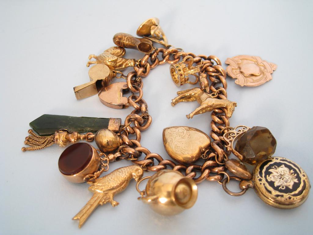 Appraisal: A ct gold Charm Bracelet with padlock fastener and approx